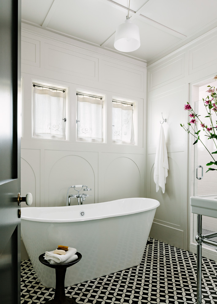 Freestanding bathtub - traditional ceramic tile and multicolored floor freestanding bathtub idea in Portland with white walls