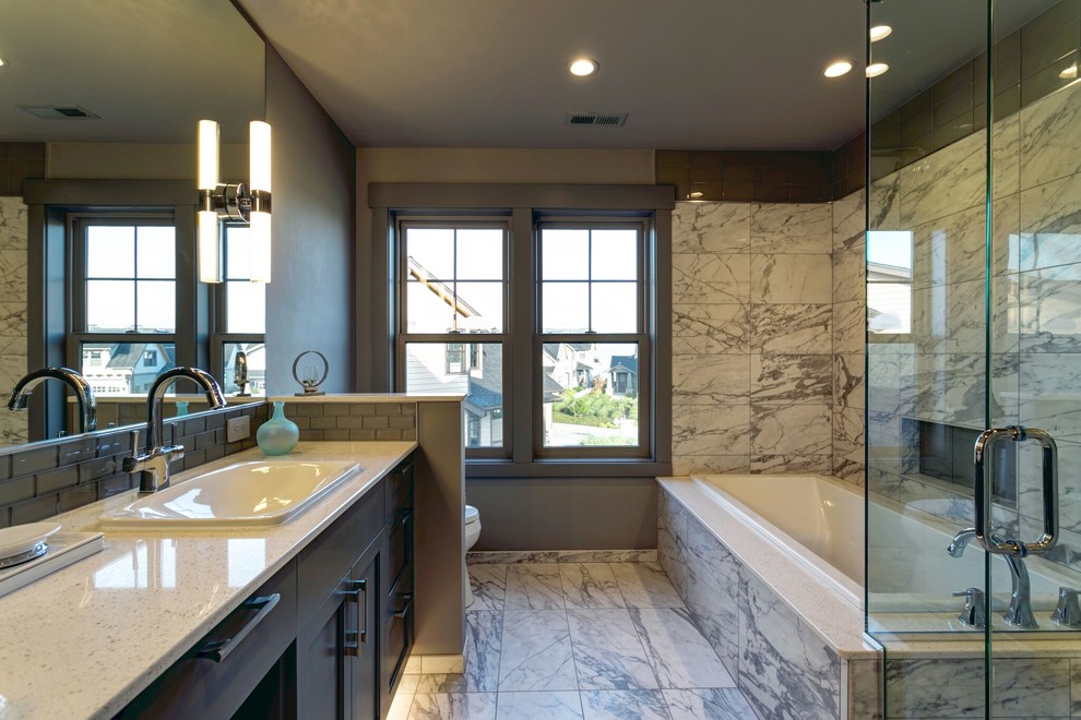 Inspiration for a mid-sized contemporary master gray tile, white tile and marble tile marble floor and multicolored floor bathroom remodel in Seattle with brown walls, a drop-in sink, quartz countertops, a hinged shower door, shaker cabinets and dark wood cabinets