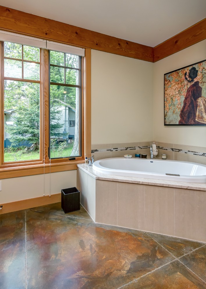 Inspiration for a large craftsman master porcelain tile concrete floor corner bathtub remodel in Seattle with an undermount sink, shaker cabinets, dark wood cabinets and granite countertops