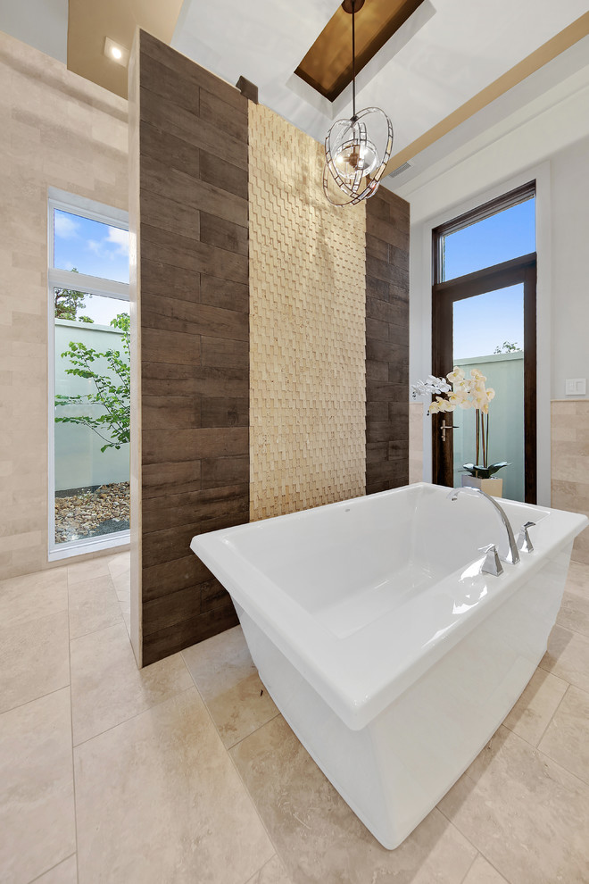 Photo of a large traditional ensuite bathroom in Austin with flat-panel cabinets, beige cabinets, a freestanding bath, a shower/bath combination, a one-piece toilet, white tiles, porcelain tiles, white walls, marble flooring, a built-in sink, marble worktops, beige floors and an open shower.