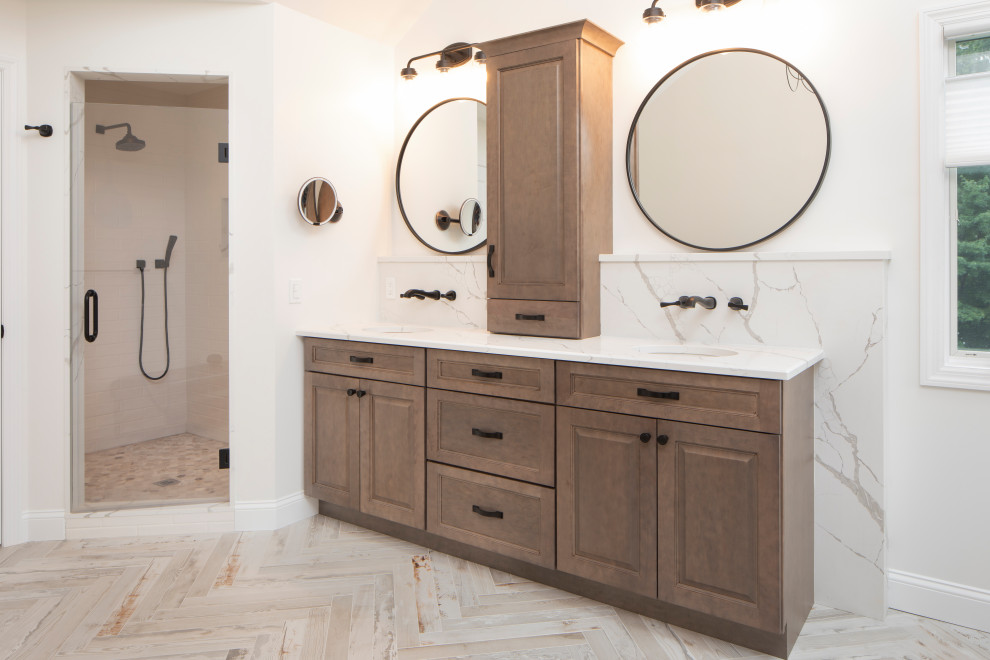 Design ideas for a large traditional ensuite bathroom in New York with raised-panel cabinets, medium wood cabinets, a two-piece toilet, white tiles, white walls, ceramic flooring, a submerged sink, engineered stone worktops, multi-coloured floors, a hinged door, white worktops, double sinks and a built in vanity unit.