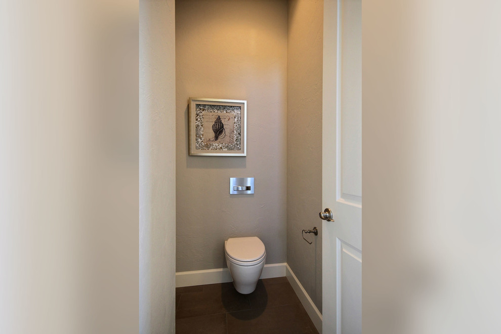 Inspiration pour un WC suspendu traditionnel en bois brun de taille moyenne avec un placard avec porte à panneau surélevé, un carrelage gris, des carreaux de béton, un mur gris, un sol en travertin, un lavabo encastré et un plan de toilette en quartz modifié.