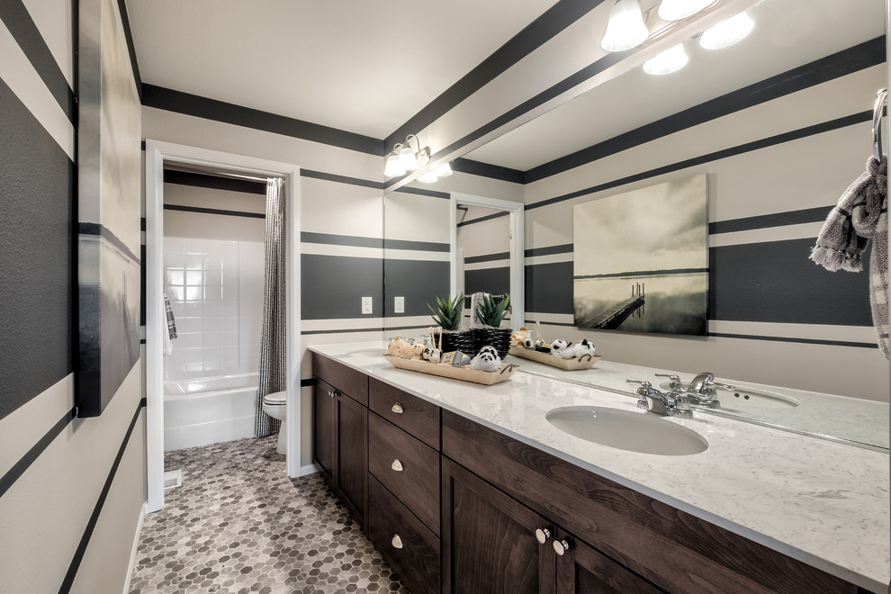 Design ideas for a large classic family bathroom in Seattle with beaded cabinets, brown cabinets, a shower/bath combination, a one-piece toilet, beige walls, laminate floors, a submerged sink, marble worktops, multi-coloured floors and white worktops.