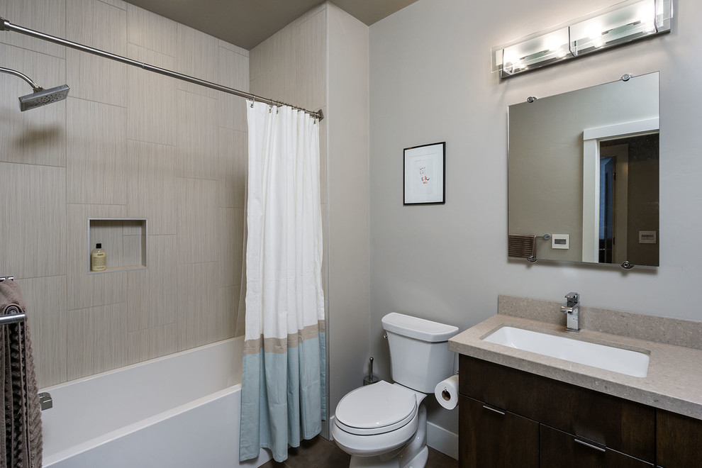Mid-sized minimalist black tile and porcelain tile porcelain tile bathroom photo in Other with an undermount sink, flat-panel cabinets, dark wood cabinets, quartz countertops, a two-piece toilet and gray walls
