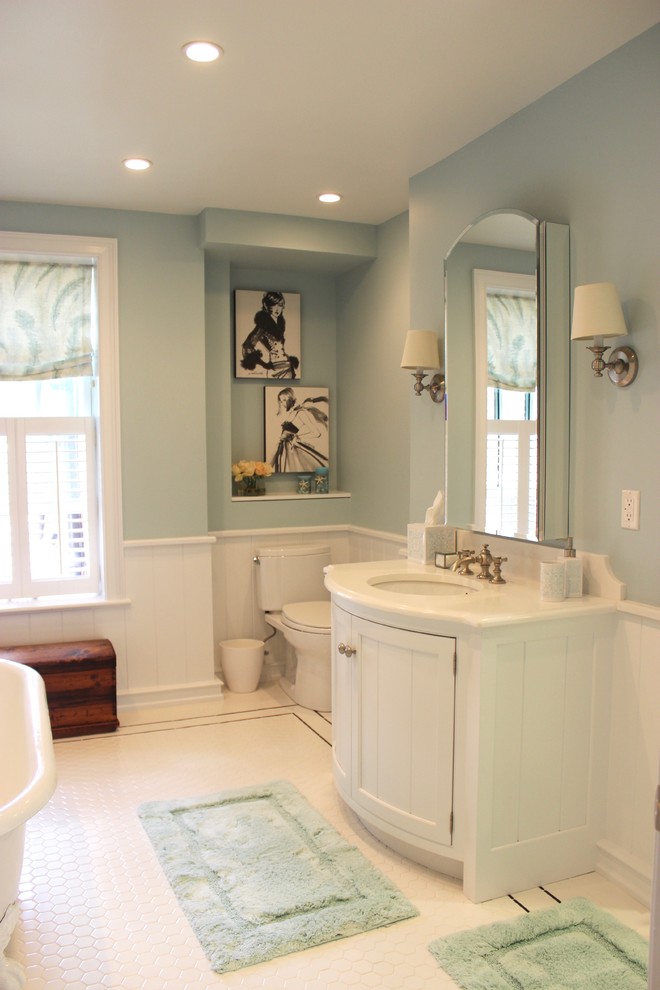 Photo of a medium sized classic ensuite bathroom in Philadelphia with recessed-panel cabinets, white cabinets, a claw-foot bath, a two-piece toilet, white tiles, ceramic tiles, blue walls, ceramic flooring and a submerged sink.