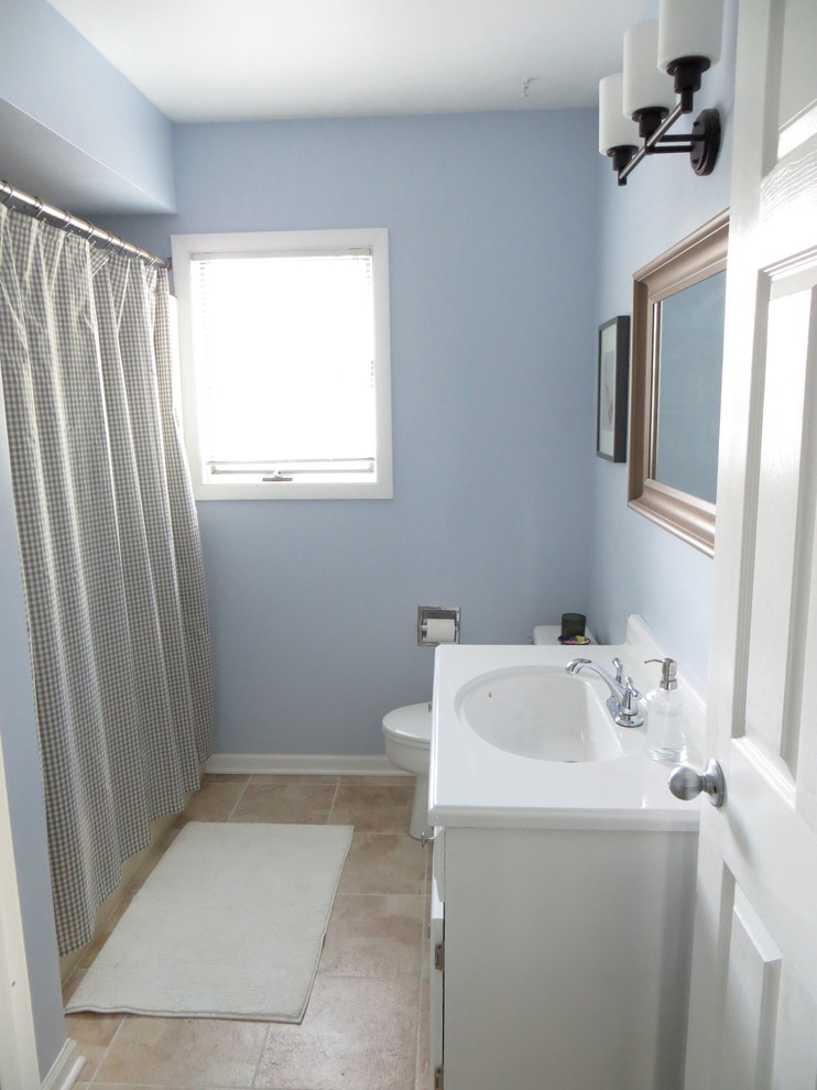 Small transitional ceramic tile bathroom photo in Chicago with white cabinets and blue walls