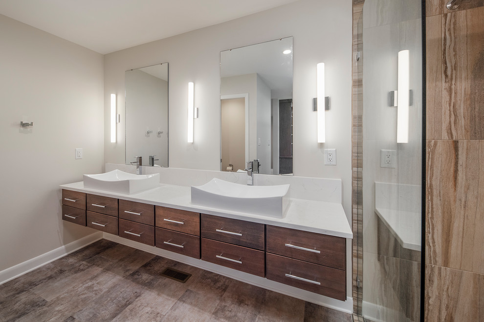 This is an example of a contemporary ensuite bathroom in Other with flat-panel cabinets, dark wood cabinets and a vessel sink.