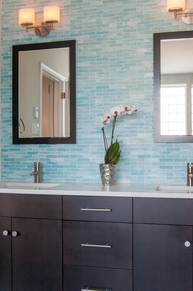 Double shower - large modern master blue tile and glass tile pebble tile floor and gray floor double shower idea in Philadelphia with an undermount sink, flat-panel cabinets, dark wood cabinets, quartz countertops, gray walls, a one-piece toilet and a hinged shower door