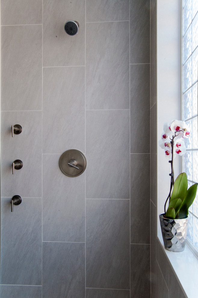 Example of a large minimalist master gray tile and porcelain tile ceramic tile doorless shower design in Philadelphia with gray walls