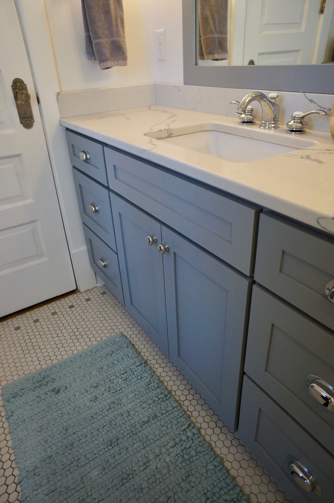 Inspiration for a small classic ensuite bathroom in Minneapolis with shaker cabinets, grey cabinets, a two-piece toilet, white tiles, metro tiles, white walls, mosaic tile flooring, a submerged sink, engineered stone worktops, a shower curtain, an alcove bath, a shower/bath combination, white floors, white worktops, a single sink and a freestanding vanity unit.