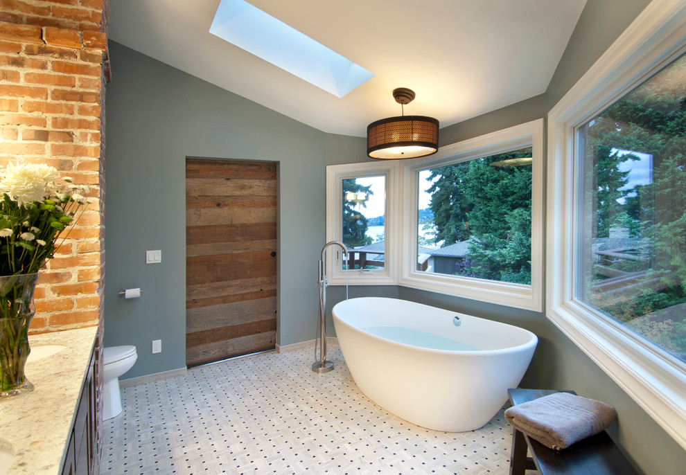 This is an example of a medium sized classic ensuite bathroom in Seattle with shaker cabinets, dark wood cabinets, a freestanding bath, an alcove shower, a two-piece toilet, white tiles, mosaic tiles, blue walls, mosaic tile flooring, a built-in sink and engineered stone worktops.