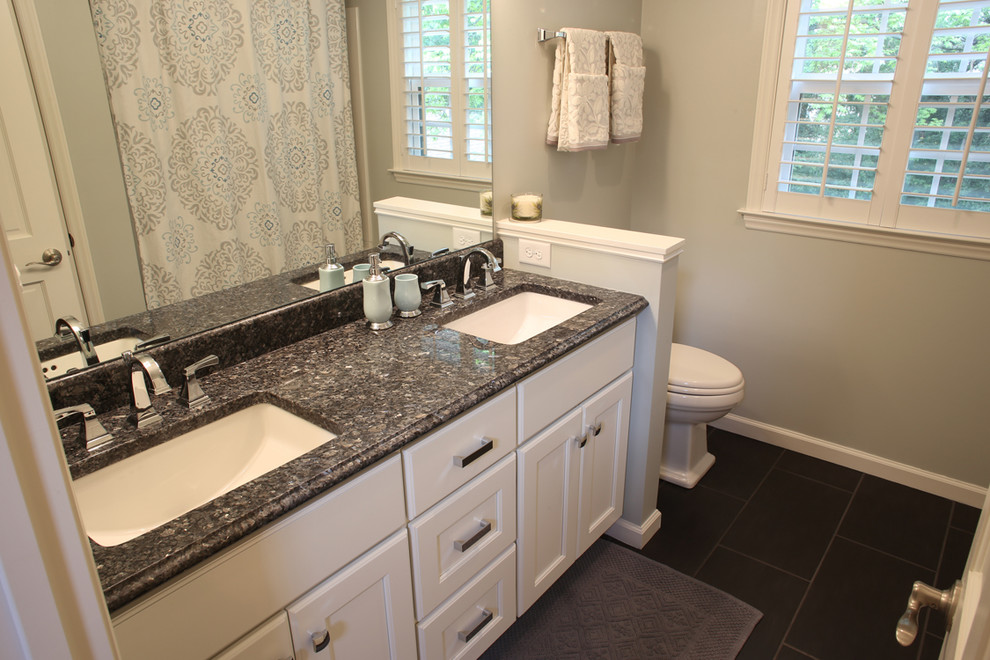Inspiration for a mid-sized transitional 3/4 black tile and terra-cotta tile slate floor bathroom remodel in Charlotte with flat-panel cabinets, white cabinets, a two-piece toilet, a wall-mount sink, granite countertops and gray walls