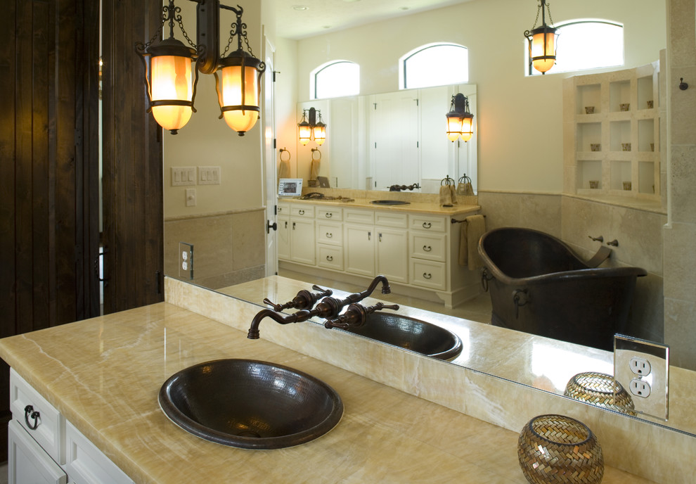 Example of a tuscan freestanding bathtub design in Houston with solid surface countertops