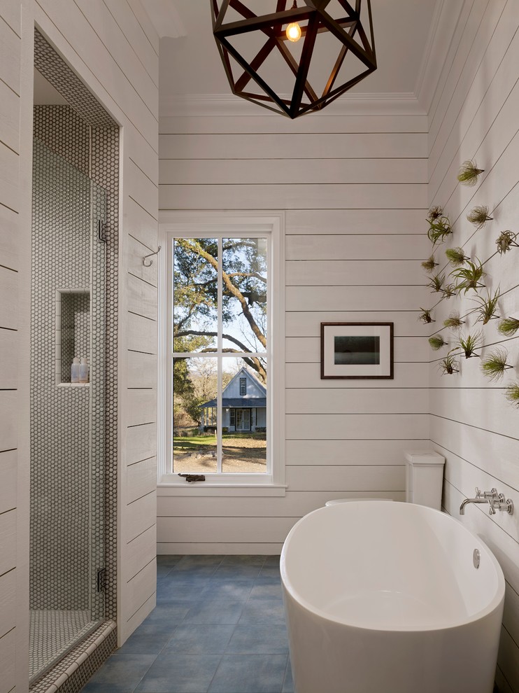 Farmhouse bathroom in San Francisco with a freestanding bath, an alcove shower, white tiles and white walls.