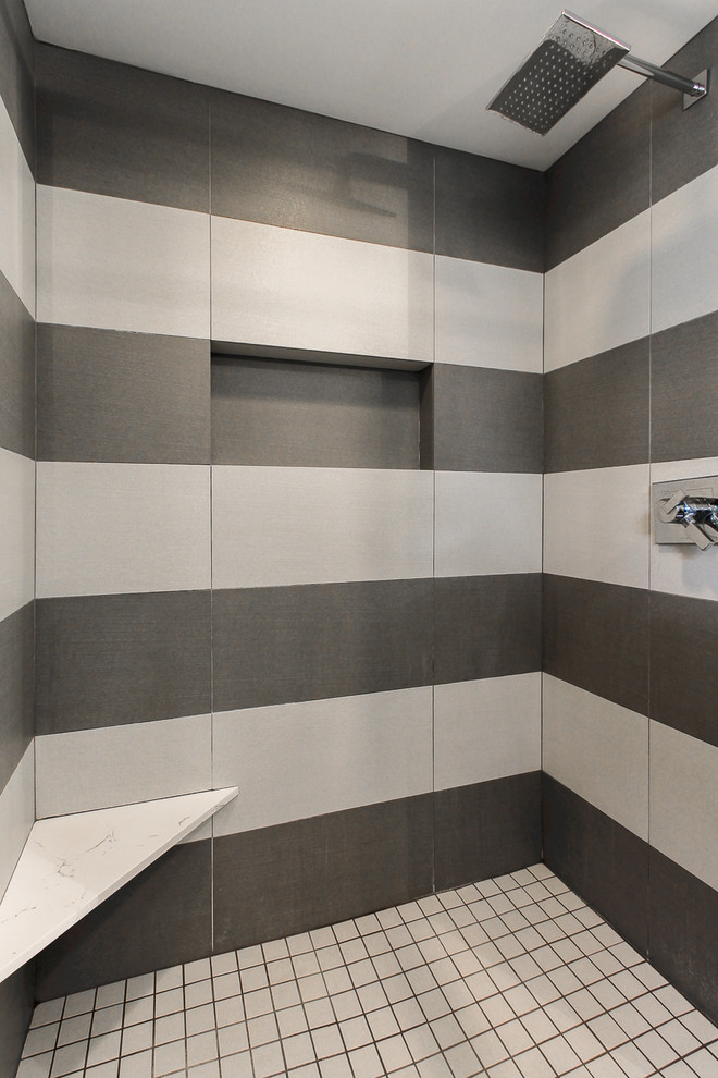 Large vintage shower room bathroom in Chicago with a submerged sink, shaker cabinets, grey cabinets, engineered stone worktops, an alcove shower, grey tiles, porcelain tiles, grey walls, a two-piece toilet and dark hardwood flooring.