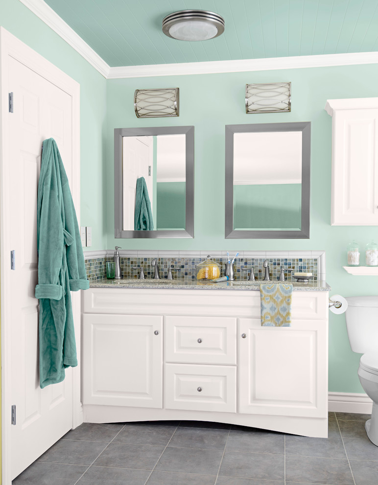 Bathroom - mid-sized transitional master multicolored tile and mosaic tile ceramic tile bathroom idea in Charlotte with an undermount sink, raised-panel cabinets, white cabinets, granite countertops, a two-piece toilet and blue walls