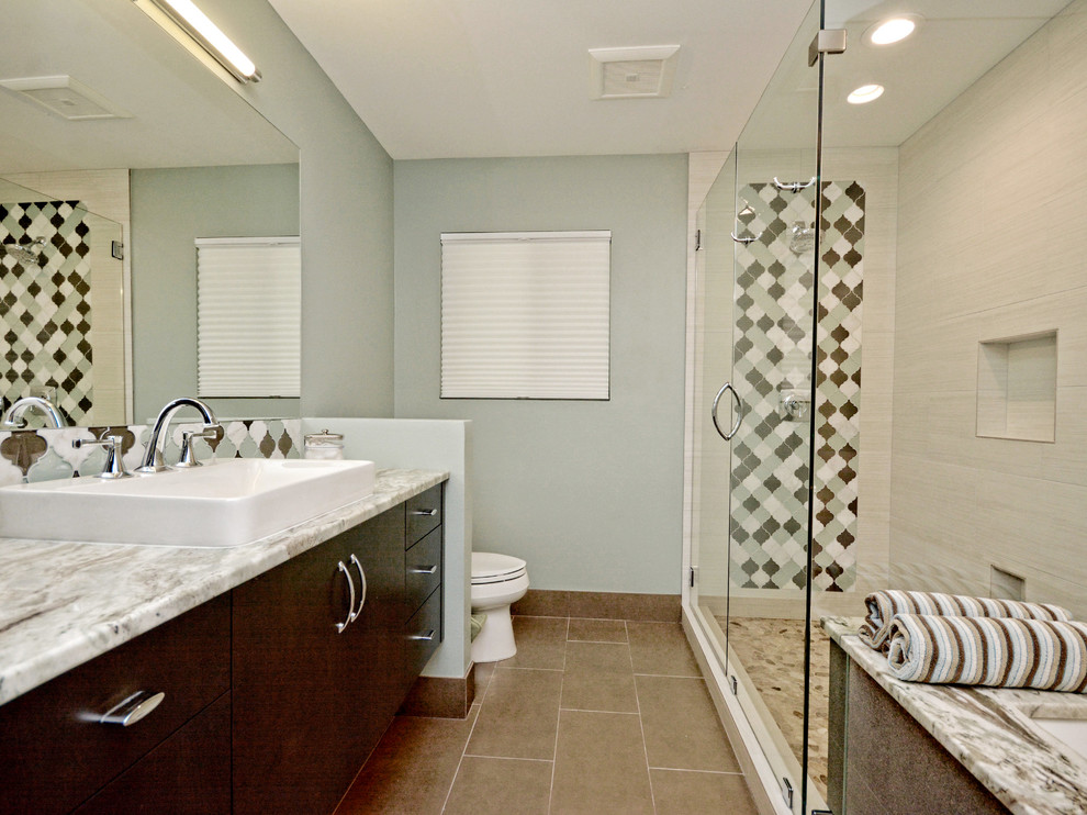 Cette photo montre une salle de bain tendance en bois foncé de taille moyenne avec un placard à porte plane, WC séparés, un carrelage marron, un carrelage vert, un carrelage blanc, mosaïque, un mur bleu, un sol en carrelage de porcelaine, un lavabo posé, un plan de toilette en granite, un sol beige et une cabine de douche à porte battante.