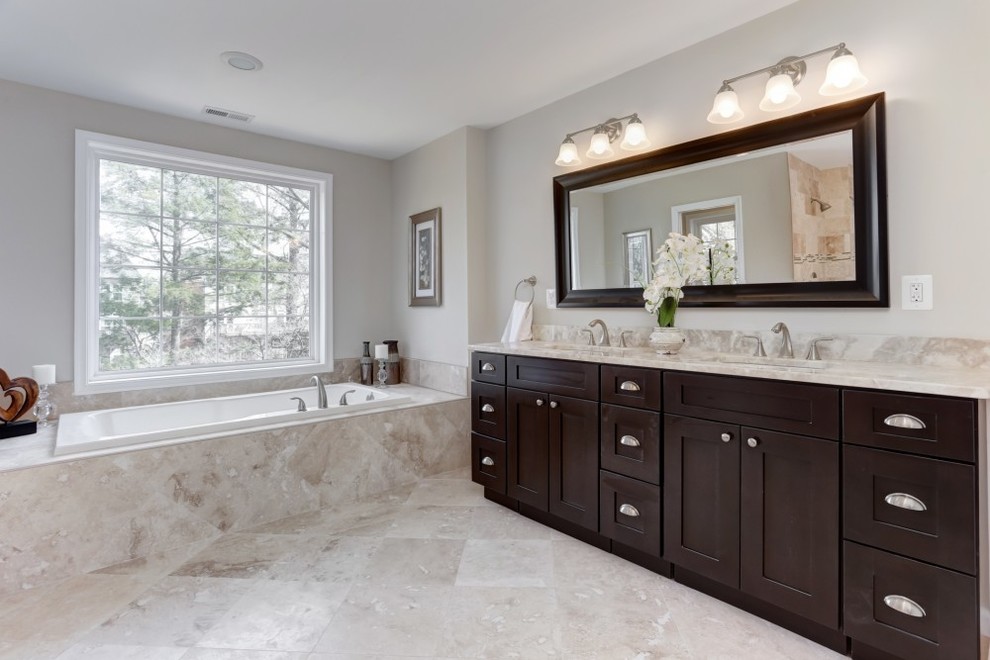 Drop-in bathtub - huge contemporary master travertine floor drop-in bathtub idea in DC Metro with an undermount sink, shaker cabinets, black cabinets, a two-piece toilet and beige walls