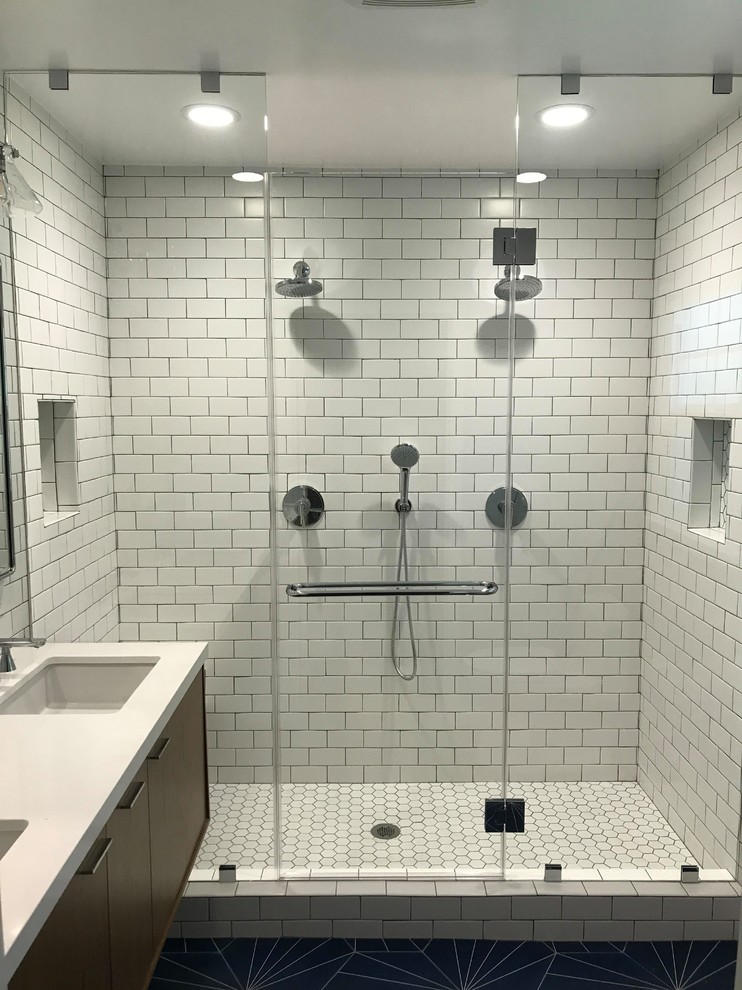 Medium sized modern ensuite bathroom in Los Angeles with flat-panel cabinets, brown cabinets, a double shower, a two-piece toilet, white tiles, metro tiles, white walls, ceramic flooring, a submerged sink, quartz worktops, blue floors, a sliding door, white worktops, a wall niche, double sinks and a floating vanity unit.