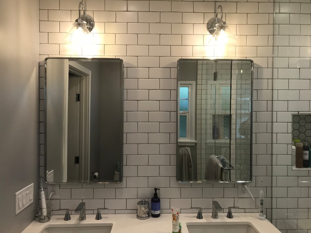 Inspiration for a medium sized farmhouse ensuite bathroom in Los Angeles with flat-panel cabinets, brown cabinets, a double shower, a two-piece toilet, white tiles, metro tiles, white walls, ceramic flooring, a submerged sink, quartz worktops, blue floors, a sliding door, white worktops, a wall niche, double sinks and a floating vanity unit.