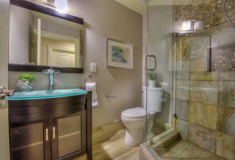 Aménagement d'une petite salle de bain principale classique en bois foncé avec un placard à porte shaker, une douche d'angle, WC séparés, un carrelage multicolore, mosaïque, un mur beige, un sol en carrelage de porcelaine, un lavabo intégré et un plan de toilette en verre.