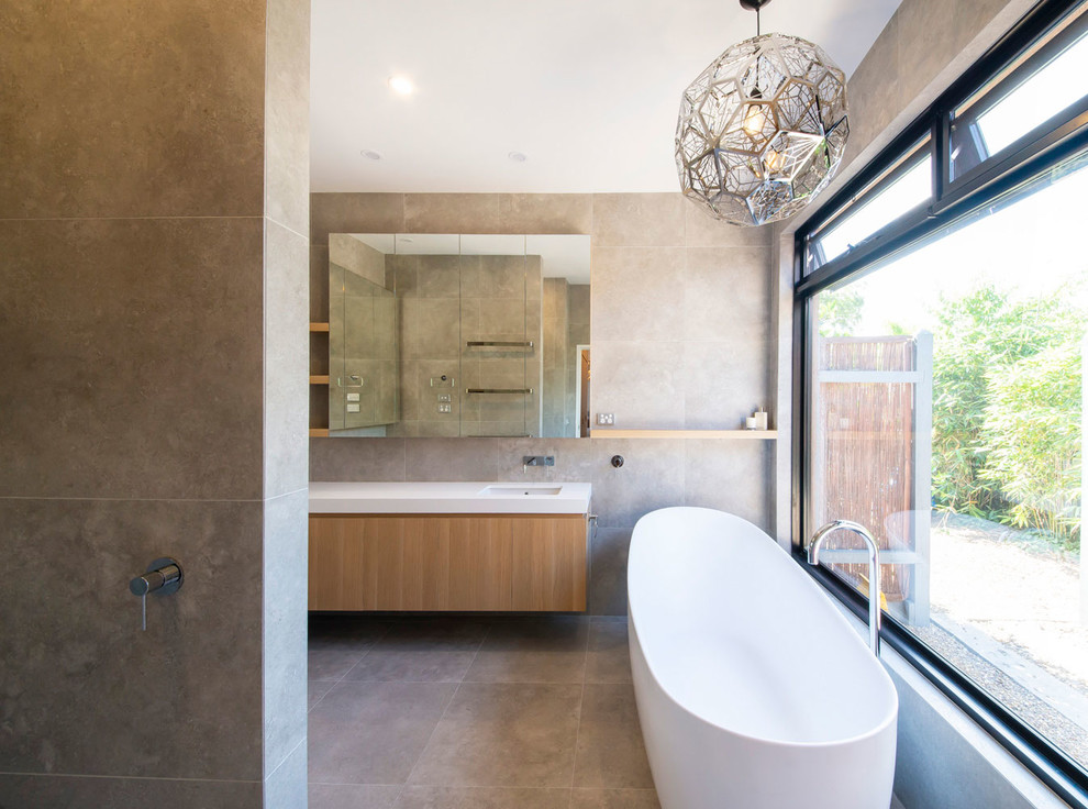 Bathroom - large modern master gray tile and ceramic tile ceramic tile and gray floor bathroom idea in Melbourne with recessed-panel cabinets, medium tone wood cabinets, a one-piece toilet, gray walls, an undermount sink, quartz countertops and white countertops