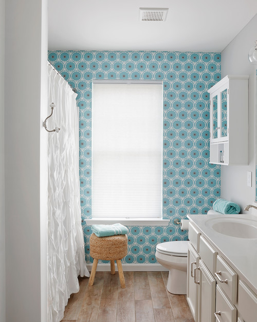 Coastal Bliss: Blue Graphic Wallpaper with White Vanity and Wicker Stool Curtain Ideas