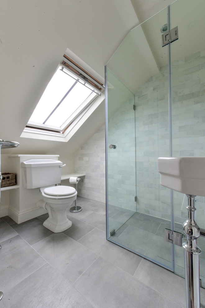 На фото: ванная комната в классическом стиле с угловым душем, раздельным унитазом, белой плиткой, каменной плиткой и серыми стенами с