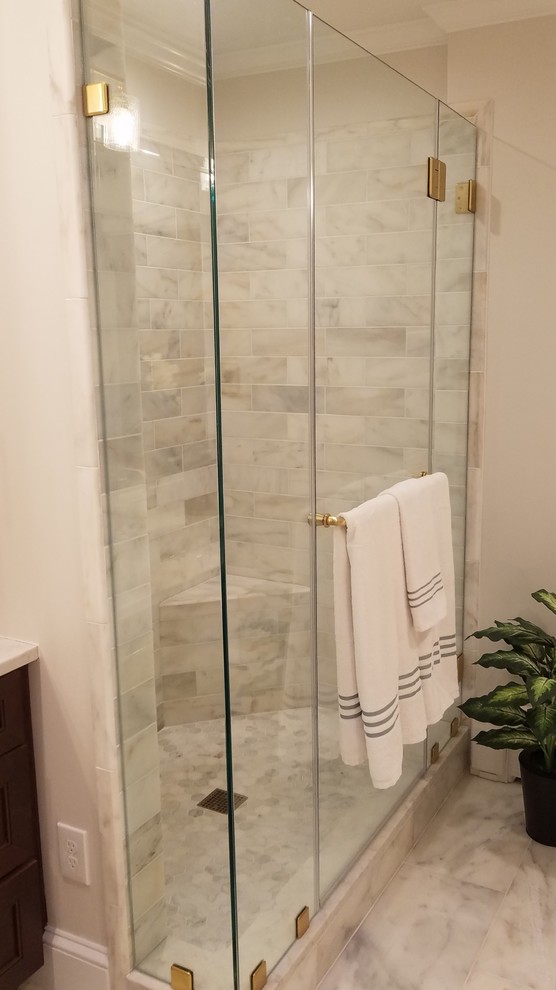 Example of a large transitional master beige tile and marble tile marble floor and beige floor corner shower design in DC Metro with shaker cabinets, dark wood cabinets, an undermount tub, a two-piece toilet, beige walls, an undermount sink, quartzite countertops, a hinged shower door and white countertops