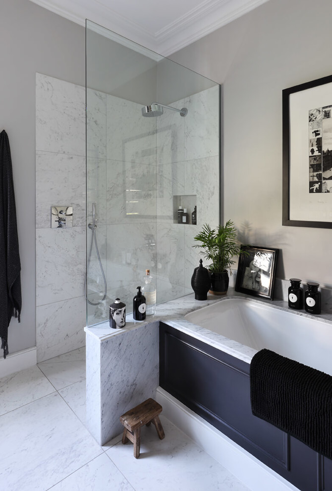 Design ideas for a large contemporary ensuite bathroom in London with raised-panel cabinets, black cabinets, a built-in bath, a corner shower, a one-piece toilet, white tiles, marble tiles, grey walls, marble flooring, an integrated sink, marble worktops, white floors, an open shower and white worktops.