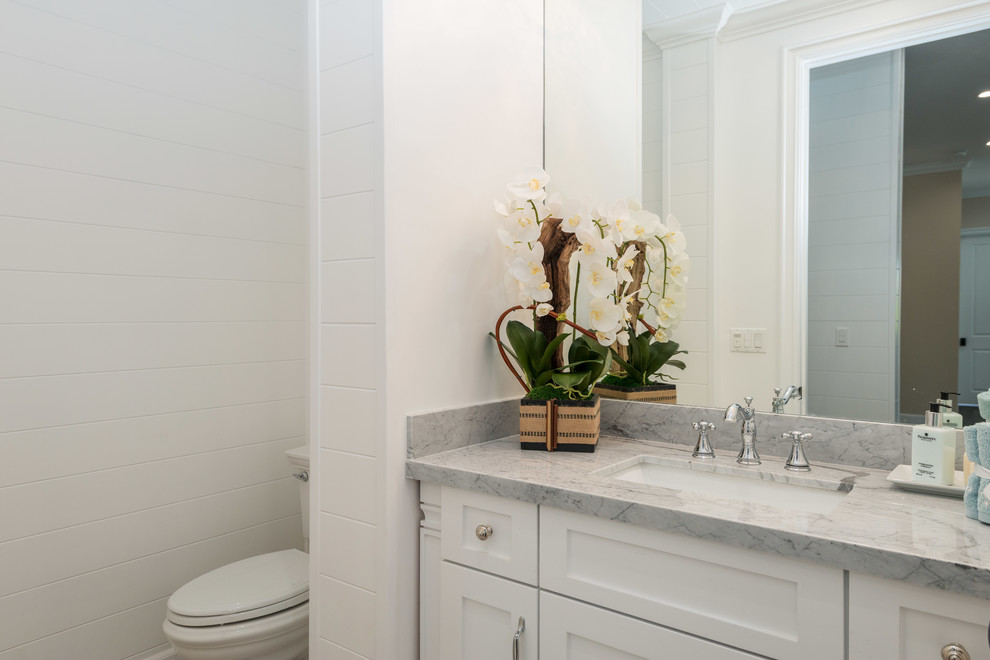 Стильный дизайн: маленькая ванная комната в стиле неоклассика (современная классика) с фасадами в стиле шейкер, белыми фасадами, унитазом-моноблоком, белой плиткой, керамической плиткой, белыми стенами, душевой кабиной, накладной раковиной, мраморной столешницей, серой столешницей, отдельно стоящей ванной, душем в нише, полом из керамической плитки, белым полом и душем с распашными дверями для на участке и в саду - последний тренд