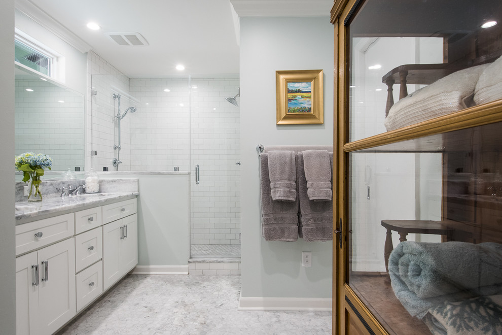 Alcove shower - mid-sized traditional master white tile and subway tile mosaic tile floor alcove shower idea in Charleston with shaker cabinets, white cabinets, blue walls, an undermount sink and marble countertops