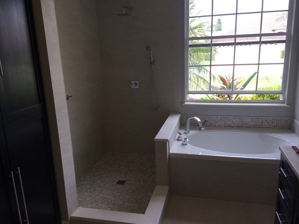 Réalisation d'une salle de bain principale minimaliste en bois foncé de taille moyenne avec un lavabo encastré, un placard en trompe-l'oeil, un plan de toilette en surface solide, une baignoire posée, une douche d'angle, WC séparés, un carrelage beige, des carreaux de porcelaine, un mur gris et un sol en carrelage de porcelaine.