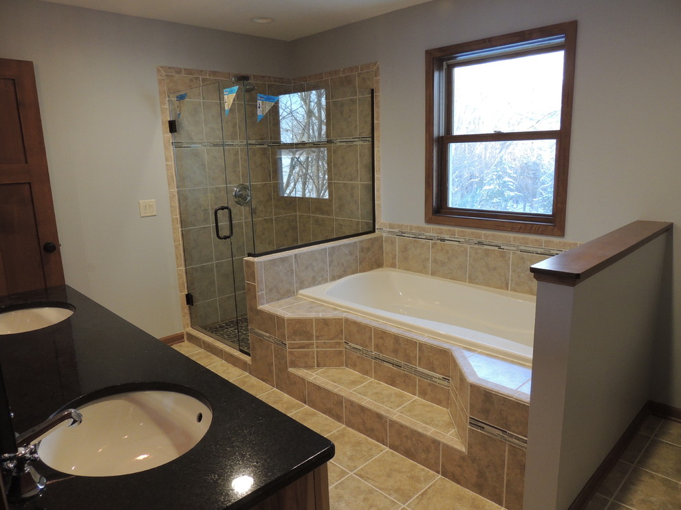 Inspiration for a craftsman master beige tile and ceramic tile ceramic tile bathroom remodel in Minneapolis with a drop-in sink, shaker cabinets, light wood cabinets, granite countertops, a two-piece toilet and gray walls