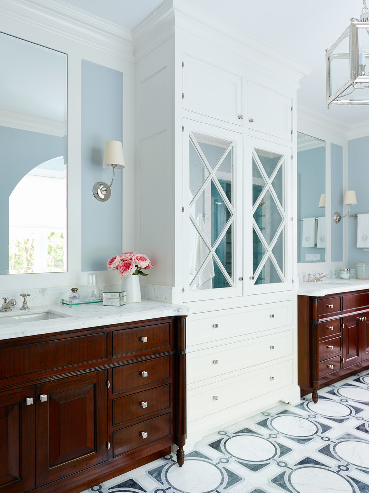 This is an example of a victorian ensuite bathroom in Jacksonville with raised-panel cabinets, dark wood cabinets, marble worktops, a submerged sink and blue walls.
