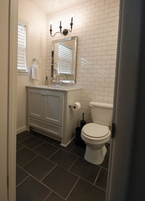 Esempio di una stanza da bagno stile americano con ante in stile shaker, ante bianche, piastrelle nere, pareti bianche e top in marmo