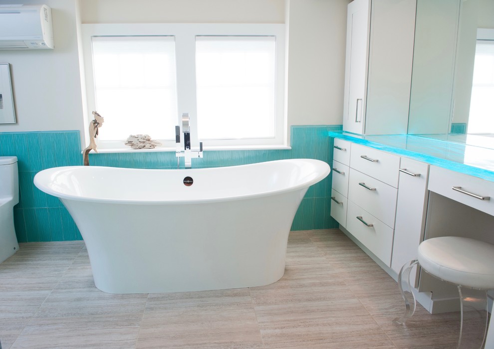 Bathroom - mid-sized eclectic master blue tile and glass tile ceramic tile bathroom idea in Providence with flat-panel cabinets, white cabinets, a one-piece toilet, white walls, glass countertops and a vessel sink