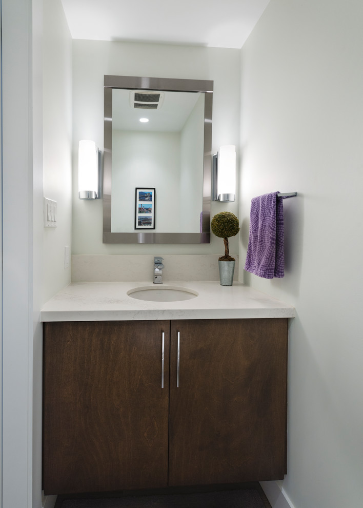 Foto de cuarto de baño costero pequeño con armarios con paneles lisos, puertas de armario marrones, paredes blancas, lavabo bajoencimera y encimera de cuarzo compacto