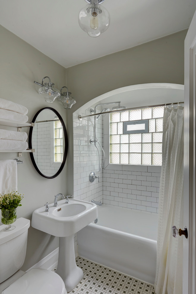 Small classic bathroom in Milwaukee with shaker cabinets, white cabinets, an alcove bath, an alcove shower, a two-piece toilet, white tiles, ceramic tiles, grey walls, ceramic flooring, a pedestal sink and a shower curtain.
