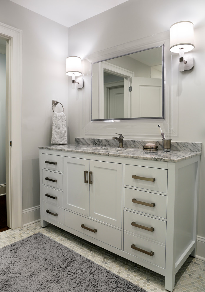 Large transitional 3/4 black tile, gray tile, white tile and stone slab mosaic tile floor bathroom photo in New York with flat-panel cabinets, white cabinets, a one-piece toilet, multicolored walls, a drop-in sink and solid surface countertops