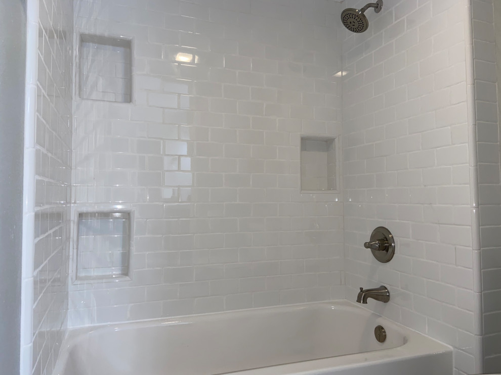 Cette photo montre une salle de bain principale chic de taille moyenne avec une baignoire en alcôve, un combiné douche/baignoire, un carrelage métro, un mur blanc et une cabine de douche avec un rideau.