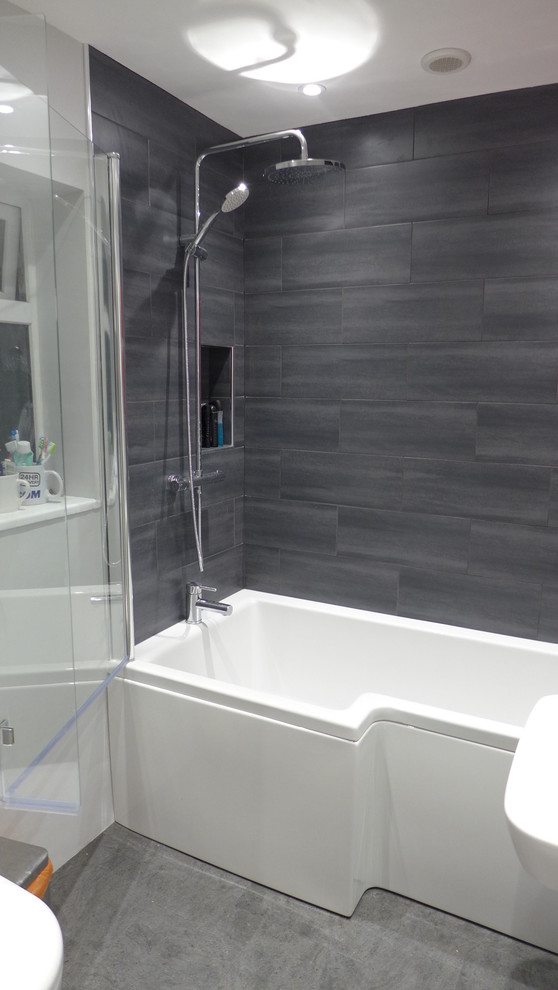 Design ideas for a small contemporary family bathroom in Other with a built-in bath, a shower/bath combination, grey tiles, ceramic tiles, grey walls and lino flooring.