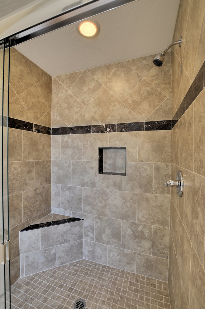 フェニックスにある地中海スタイルのおしゃれなマスターバスルーム (アルコーブ型シャワー、茶色いタイル、石タイル、磁器タイルの床) の写真