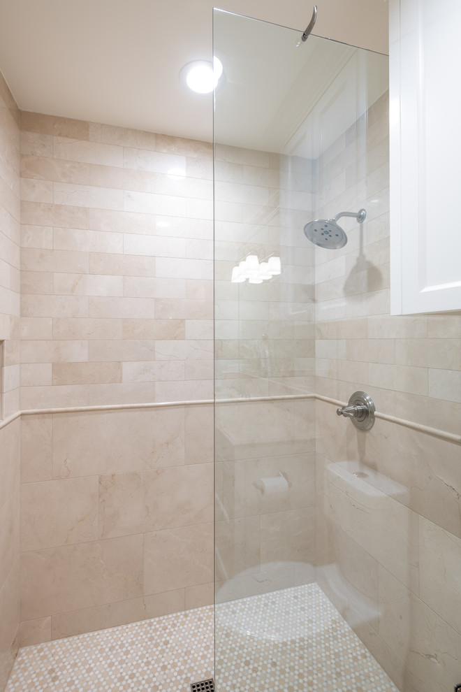 Inspiration for a mid-sized timeless kids' beige tile and marble tile marble floor and beige floor alcove shower remodel in Dallas with shaker cabinets, white cabinets, a two-piece toilet, green walls, an undermount sink, limestone countertops, a hinged shower door and beige countertops
