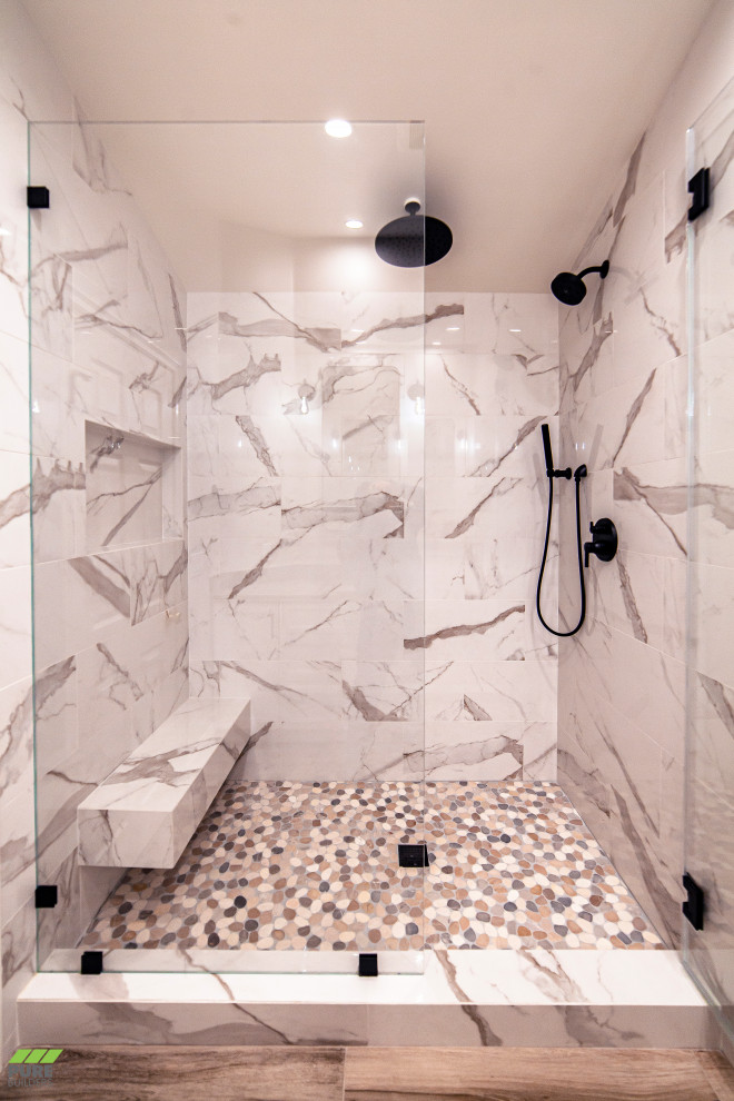 Foto på ett mellanstort funkis grå en-suite badrum, med skåp i shakerstil, vita skåp, en dusch i en alkov, en toalettstol med hel cisternkåpa, grå väggar, ett undermonterad handfat, bänkskiva i kvarts, brunt golv och dusch med gångjärnsdörr