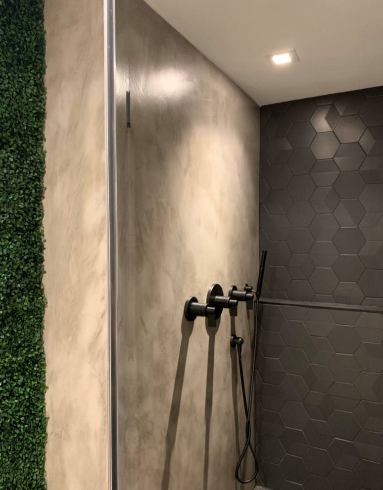 Inspiration for a large modern master black tile and porcelain tile concrete floor and gray floor bathroom remodel in Miami with medium tone wood cabinets, a one-piece toilet, white walls, an undermount sink, marble countertops, a hinged shower door and white countertops