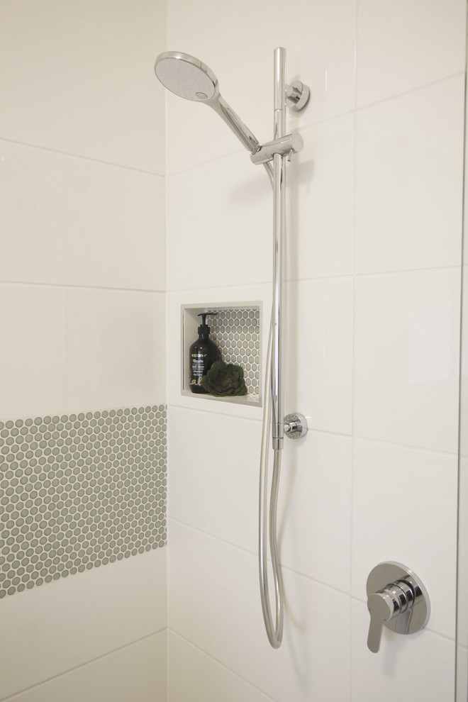 Design ideas for a small contemporary family bathroom in Brisbane with flat-panel cabinets, green cabinets, a built-in bath, a built-in shower, a two-piece toilet, white tiles, mosaic tiles, white walls, porcelain flooring, a vessel sink, engineered stone worktops, beige floors, a hinged door and white worktops.