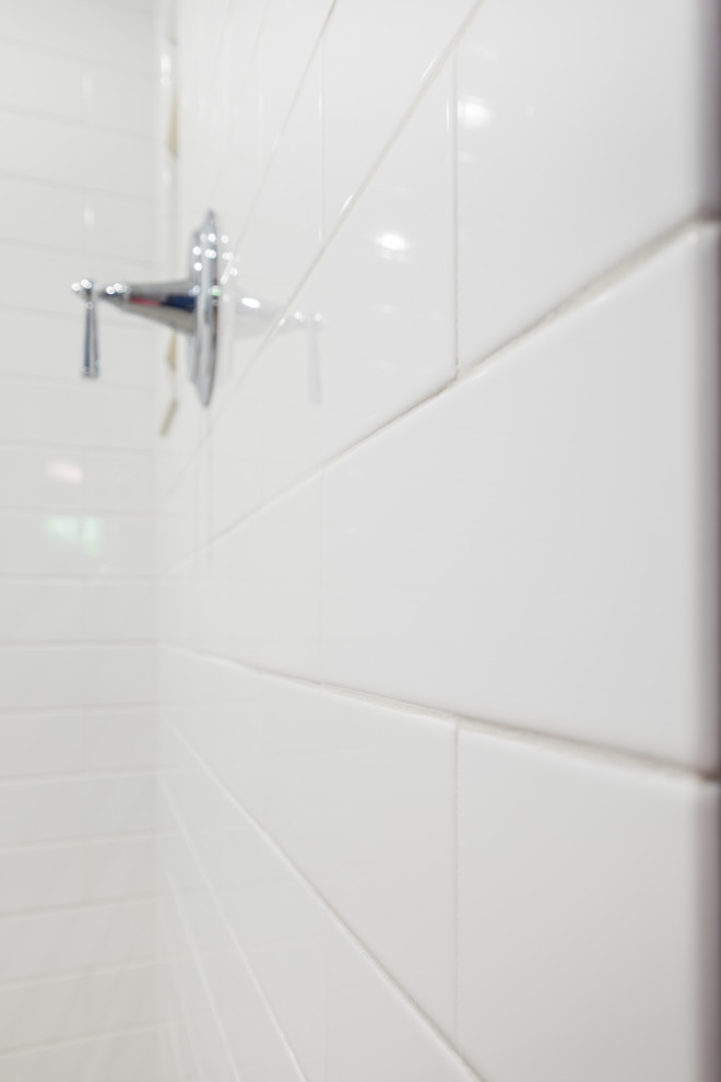 Bathroom - mid-sized traditional master white tile and ceramic tile porcelain tile bathroom idea in Portland with recessed-panel cabinets, white cabinets, a two-piece toilet, blue walls, an undermount sink and quartz countertops