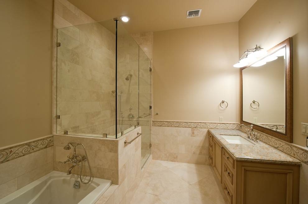 Inspiration for a mid-sized timeless 3/4 beige tile and stone tile travertine floor bathroom remodel in Phoenix with an undermount sink, raised-panel cabinets, light wood cabinets, granite countertops and beige walls