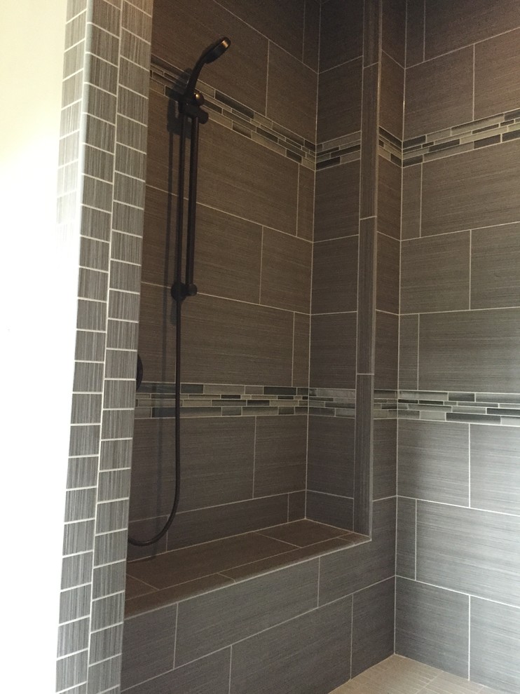 Medium sized modern ensuite bathroom in Seattle with a walk-in shower, grey tiles, porcelain tiles and mosaic tile flooring.